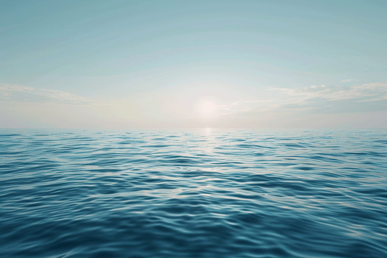 A calm ocean horizon under a wide open sky with gentle waves