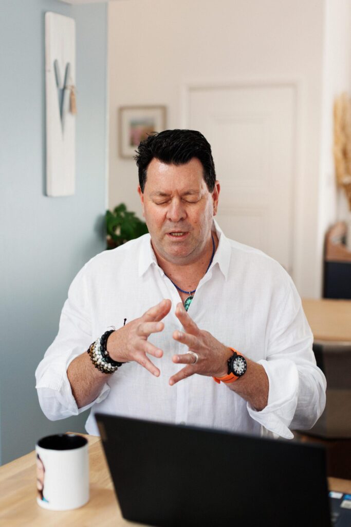Andy Porter working at his laptop with his eyes closed